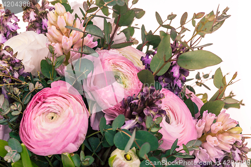 Image of Ranunkulyus bouquet of red flowers on a white background