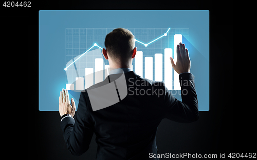 Image of businessman touching virtual screen with chart