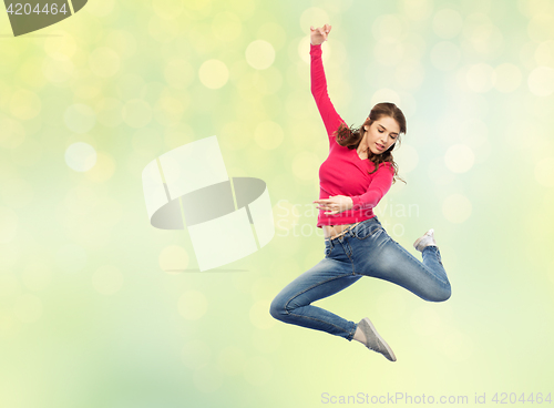 Image of smiling young woman jumping in air