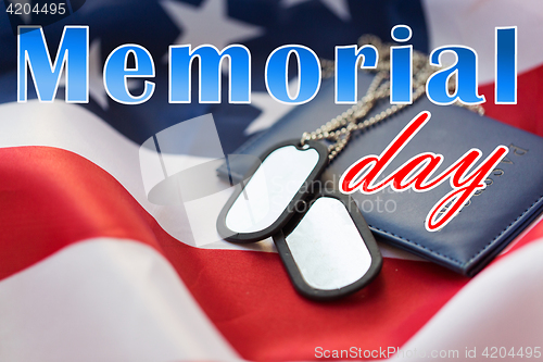 Image of memorial day words on american flag and dog tags