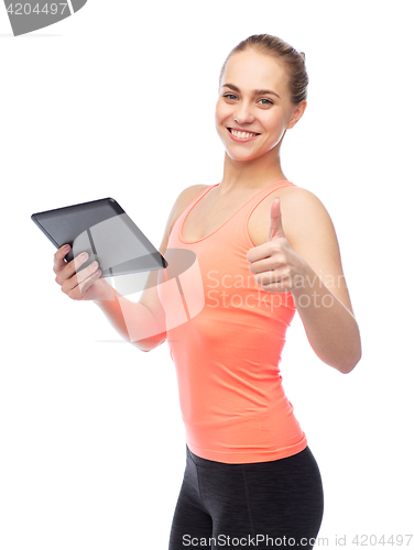 Image of happy smiling sportive young woman with tablet pc
