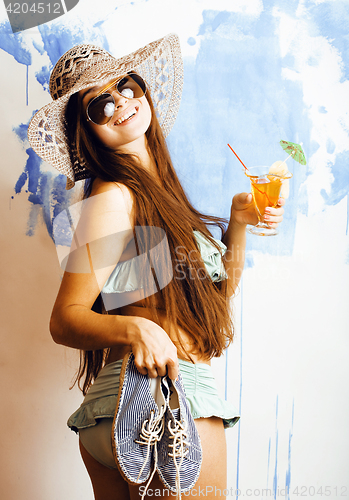 Image of cute bright woman in sunglasses and hat with cocktail in bikini 