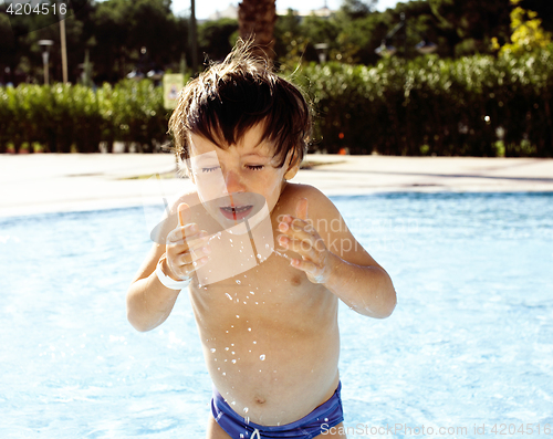 Image of little cute real boy in swimming pool close up smiling