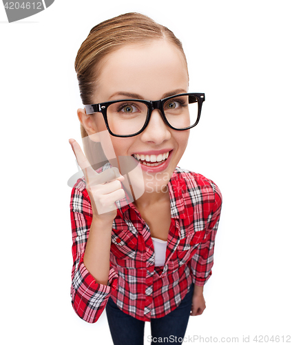 Image of smiling teenager in eyeglasses with finger up