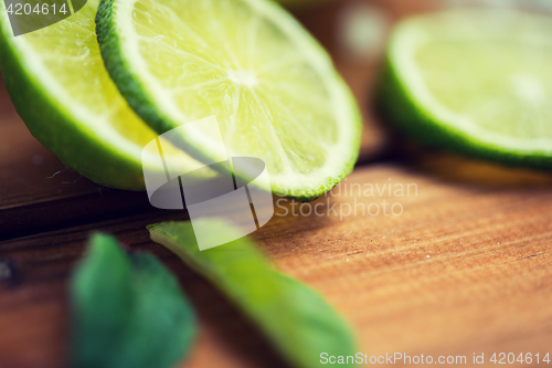 Image of lime slices on wooden table