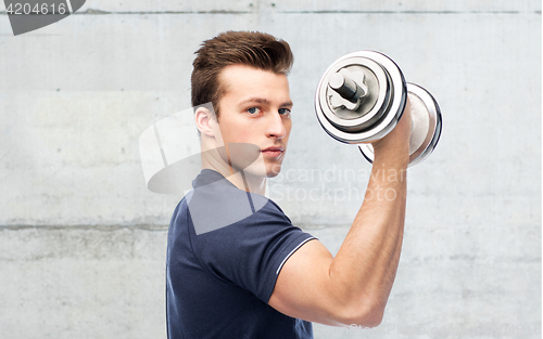 Image of sportive man flexing muscles with dumbbell