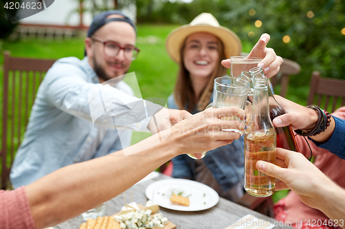 Image of happy friends with drinks at summer garden party