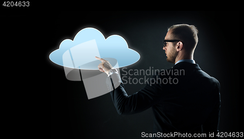 Image of businessman pointing finger to cloud projection