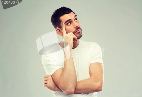 Image of man thinking over gray background