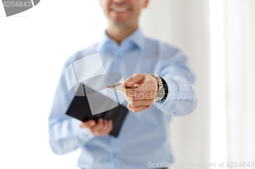 Image of close up of businessman with credit card