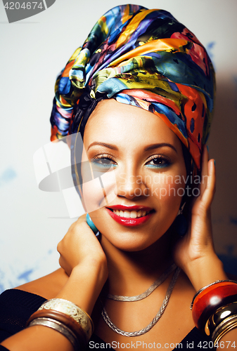 Image of beauty bright african woman with creative make up, shawl on head