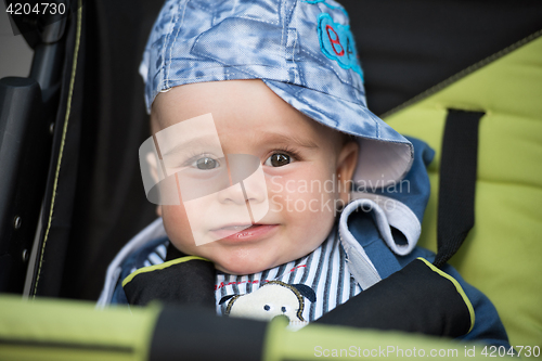 Image of baby boy sitting in the pram