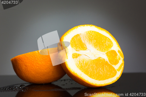 Image of Sliced orange fruit on gray background