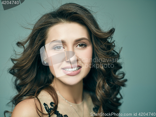 Image of Pretty girl with long hair smiling and enjoying life
