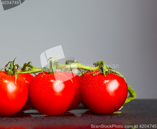 Image of The fresh cherry tomatos on gray background