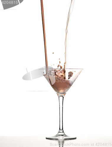 Image of macro shoot with hot chocolate falling in glass on white in studio