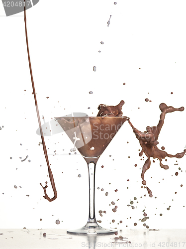 Image of macro shoot with hot chocolate falling in glass on white in studio