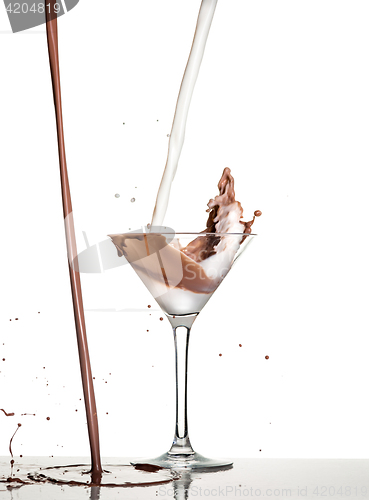 Image of macro shoot with hot chocolate falling in glass on white in studio