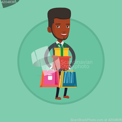 Image of Happy man holding shopping bags and gift boxes.