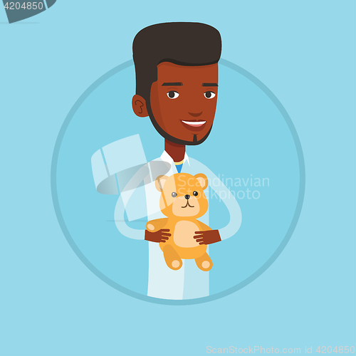 Image of Pediatrician doctor holding teddy bear.