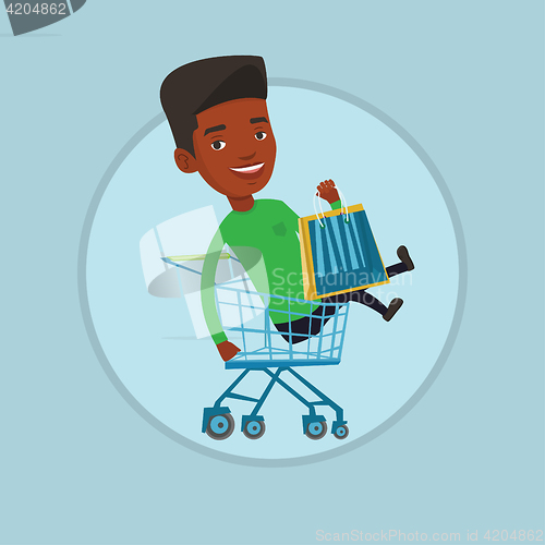 Image of Happy man riding by shopping trolley.