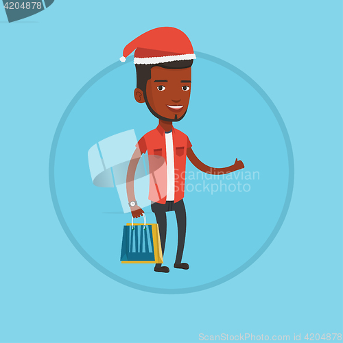 Image of Man in santa hat shopping for christmas gifts.