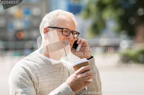 Image of happy senior man calling on smartphone in city