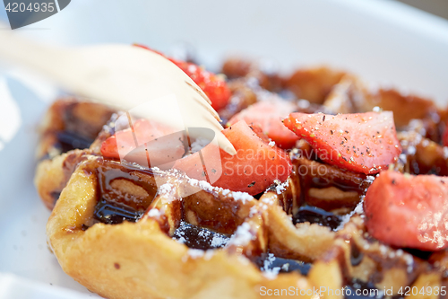 Image of waffle with strawberry and sauce