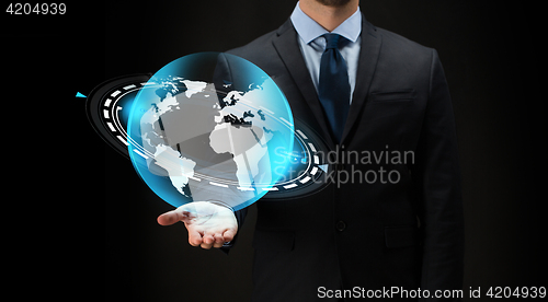 Image of businessman with virtual earth projection