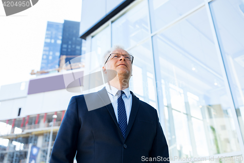 Image of senior businessman on city street