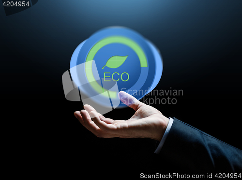 Image of close up of businessman hand with eco icon