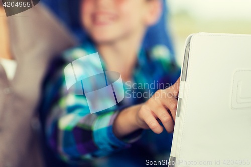 Image of close up of boy with tablet pc in travel bus