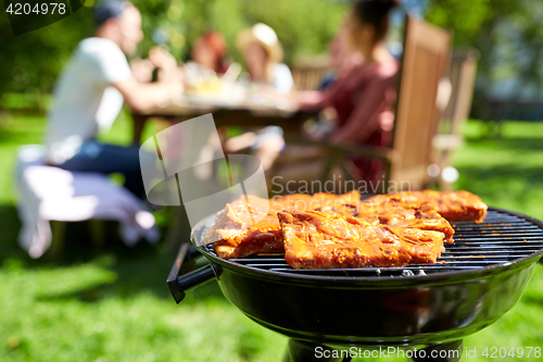 Image of meat cooking on barbecue grill at summer party