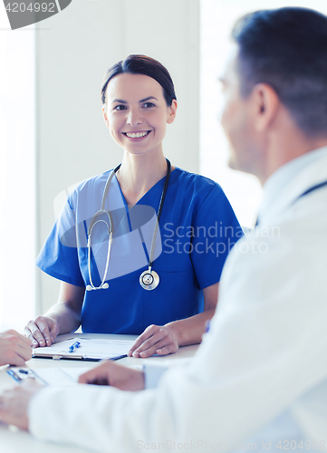 Image of group of happy doctors meeting at hospital office