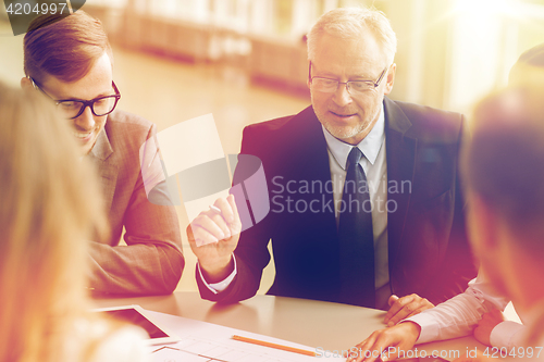 Image of architects with tablet pc and blueprint at office