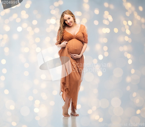 Image of happy pregnant woman touching her big belly