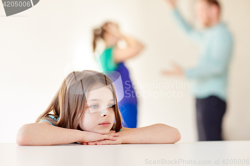 Image of beautiful sad girl and parents arguing at home