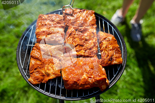 Image of meat cooking on barbecue grill at summer party