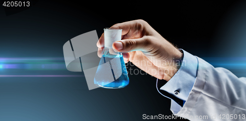 Image of close up of scientist holding flask with chemical