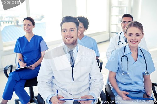 Image of group of happy doctors on seminar at hospital