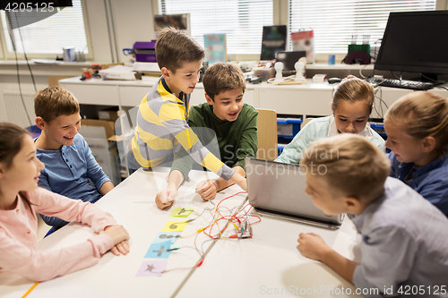 Image of kids, laptop and invention kit at robotics school