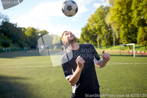 Image of soccer player playing with ball on field