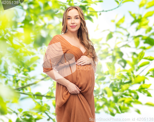 Image of happy pregnant woman over summer green background