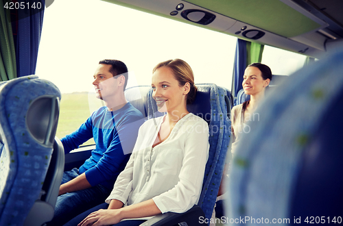 Image of group of happy passengers in travel bus