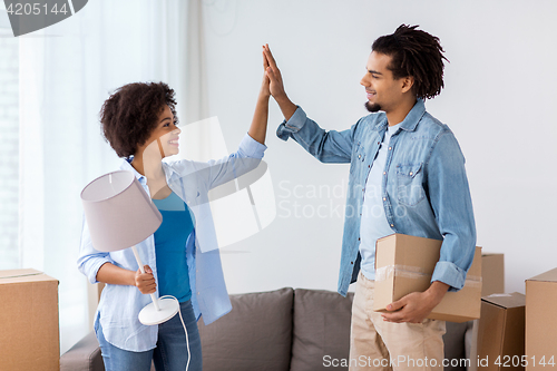 Image of happy couple with stuff moving to new home
