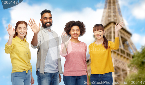 Image of international group of happy people waving hands