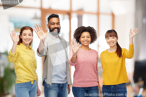 Image of international group of happy people waving hands