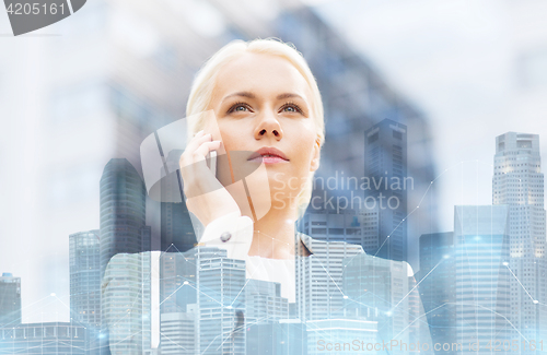 Image of serious businesswoman with smartphone in city