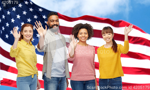 Image of international group of happy people waving hands