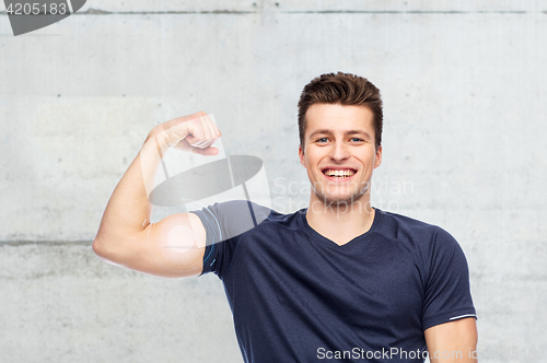 Image of sportive man showing bicep power